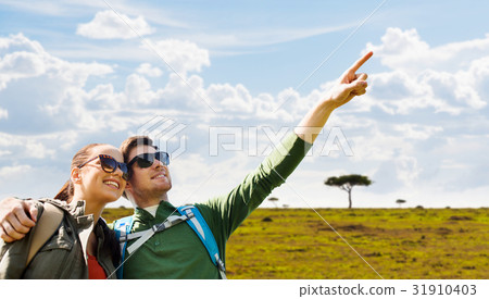 happy couple with backpacks traveling in africa 31910403