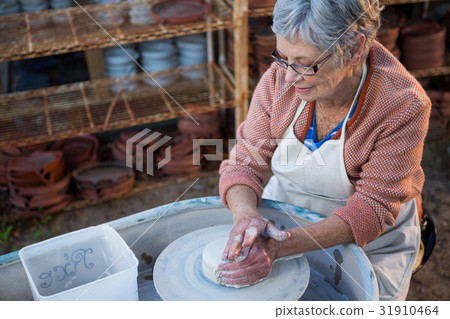 Female potter making pot 31910464