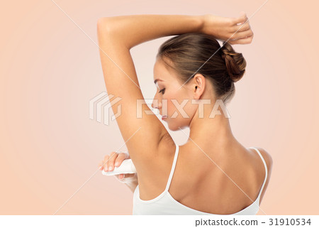 woman with antiperspirant deodorant over white 31910534