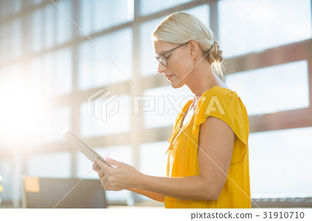Business executive using digital tablet Business executive using digital tablet 31910710