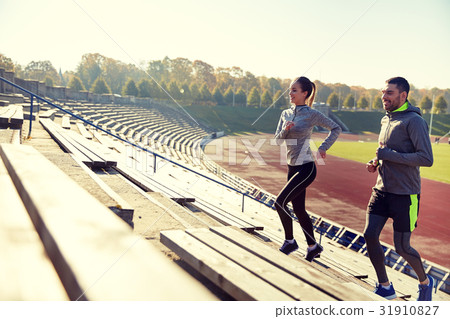 happy couple running upstairs on stadium 31910827