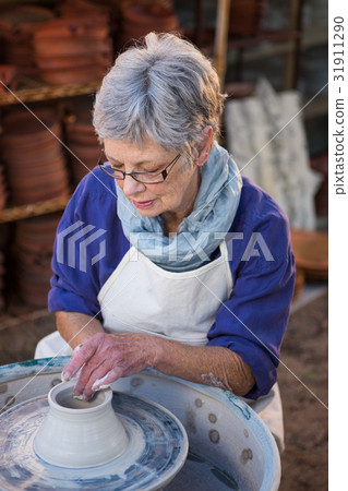Female potter making pot Female potter making pot 31911290