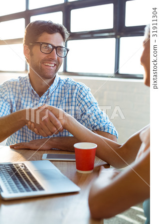 Business executive shaking hands with coworker Business executive shaking hands with coworker 31911304