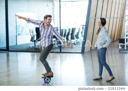 Graphic designer standing on hoverboard Graphic designer standing on hoverboard 31911344
