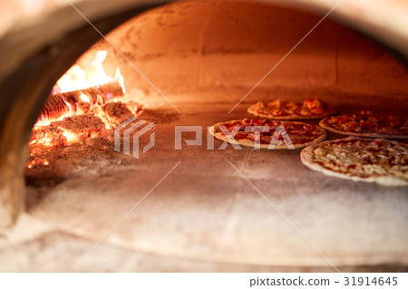pizza baking in oven at pizzeria pizza baking in oven at pizzeria 31914645