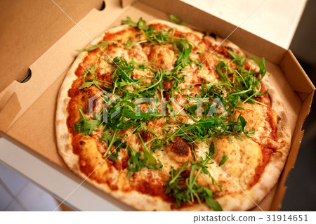 close up of pizza in box on table at pizzeria 31914651