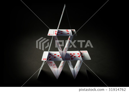 house of playing cards over black background 31914762