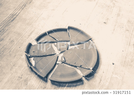 broken plate lying on a wooden table broken plate lying on a wooden table 31917151