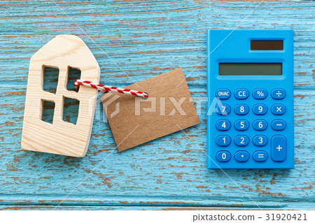 Wood house with calculator and blank label 31920421