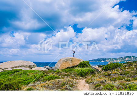 Tourist on top of sandstone rock near Costa Serena 31921950