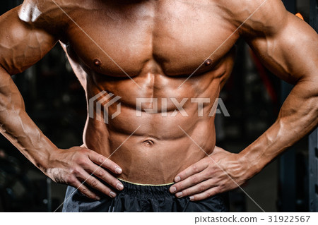 Caucasian sexy fitness model in gym close up abs. 31922567