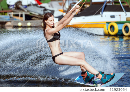 Woman in a swimsuit surfs. Woman in a swimsuit surfs. 31923064