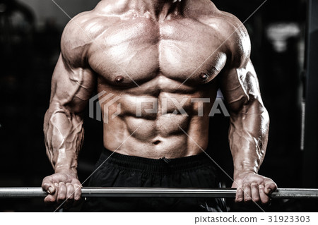 Handsome power athletic man on diet training pumping up muscles Handsome power athletic man on diet training pumping up muscles 31923303