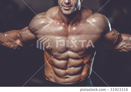 Caucasian sexy fitness model in gym close up abs. 31923318