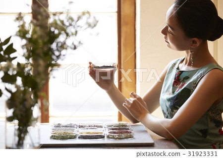 A woman enjoying tea A woman enjoying tea 31923331
