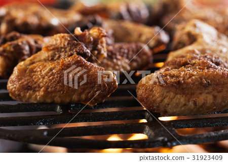 Grilling chicken wings on barbecue grill 31923409