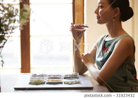 A woman enjoying tea A woman enjoying tea 31923432