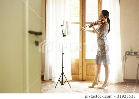 A woman playing a violin 31923535