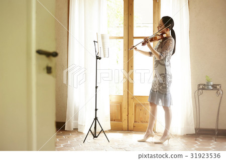 A woman playing a violin A woman playing a violin 31923536