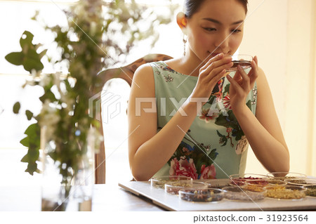 A woman enjoying tea 31923564
