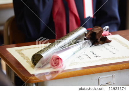 Diploma and flower bouquet on graduate desk 31923874