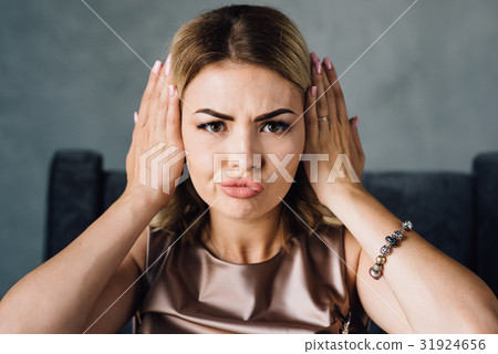 Happy woman covering her ears with hands 31924656
