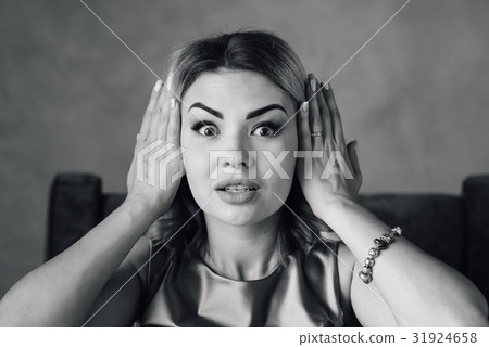 Happy woman covering her ears with hands 31924658