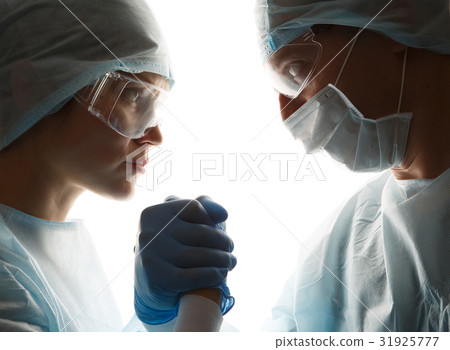 Doctors in gloves make handshake Doctors in gloves make handshake 31925777