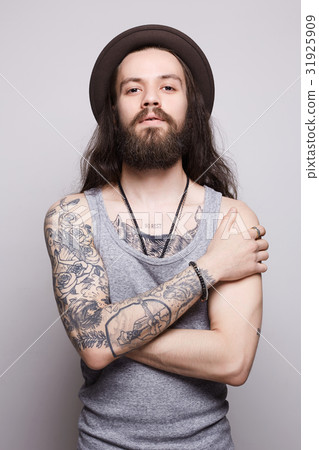 tattoed handsome bearded man in hat tattoed handsome bearded man in hat 31925909