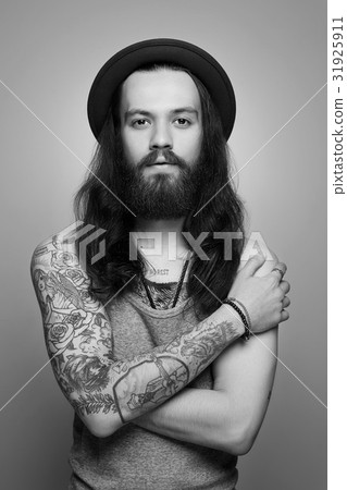 tattooed handsome bearded man in hat tattooed handsome bearded man in hat 31925911