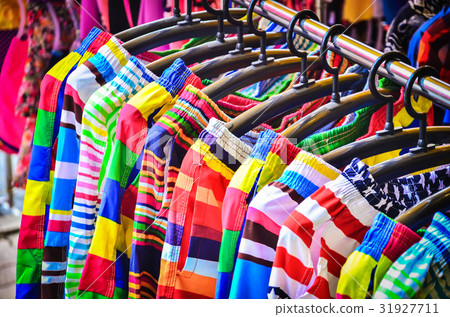 Colorful Pants hanging on a rack. Colorful Pants hanging on a rack. 31927711