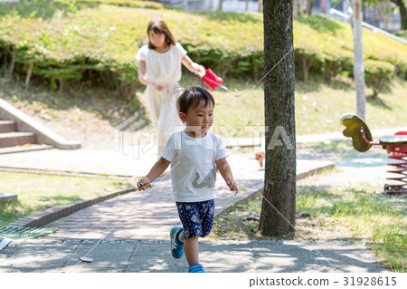 Parents and dogs playing in the park 31928615