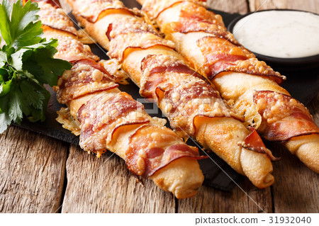 Bread sticks with bacon and cheese close-up Bread sticks with bacon and cheese close-up 31932040