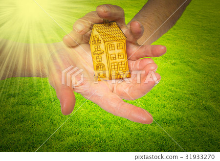 bright picture of woman holding wooden house 31933270