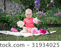 Little girl is playing with flowers, 31934025