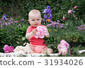 Little girl is playing with flowers, 31934026