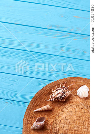 Surface with hat and sea shells. Surface with hat and sea shells. 31934856