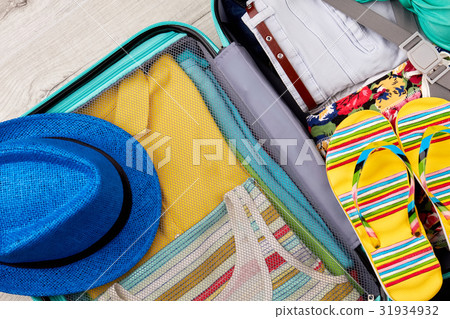 Opened full suitcase close up. Opened full suitcase close up. 31934932