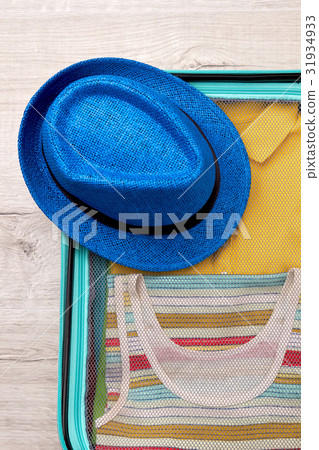 Hat, packed suitcase for trip. Hat, packed suitcase for trip. 31934933
