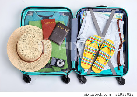 Beach accessories in opened suitcase. Beach accessories in opened suitcase. 31935022
