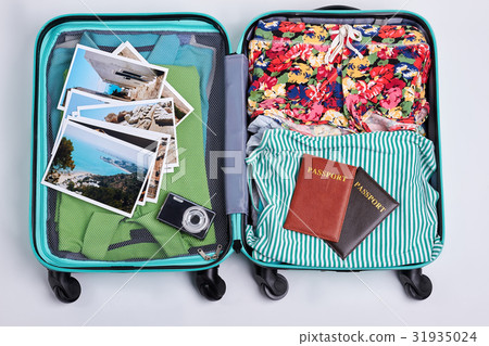 Summer clothes in opened suitcase. Summer clothes in opened suitcase. 31935024