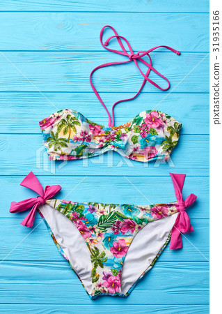 Flowery swimsuit, wooden background. Flowery swimsuit, wooden background. 31935166