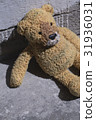Old plush toy on the concrete floor. 31936031