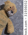 Old plush toy on the concrete floor. 31936032
