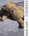 Old plush toy on the concrete floor. 31936033