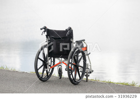 Empty wheelchair on lake 31936229