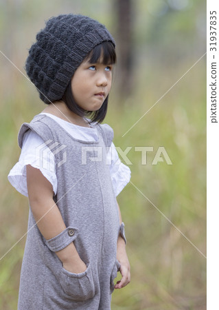 funny face of asian girl standing on field funny face of asian girl standing on field 31937835