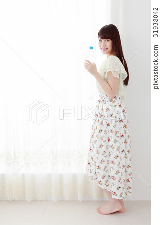 A young lady with hydration supplement PET bottle A young lady with hydration supplement PET bottle 31938042