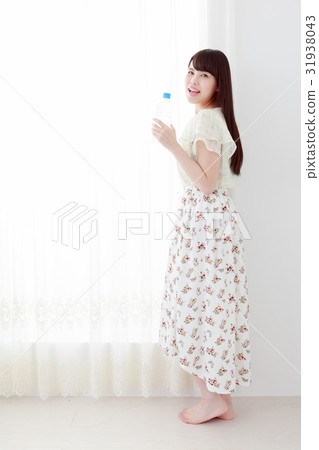 A young lady with hydration supplement PET bottle 31938043