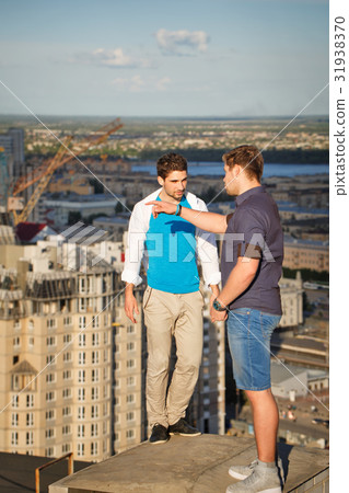 Two roofers on housetop 31938370